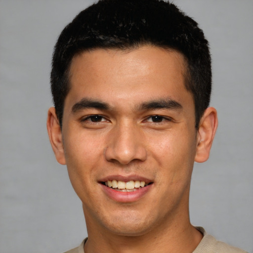 Joyful white young-adult male with short  black hair and brown eyes