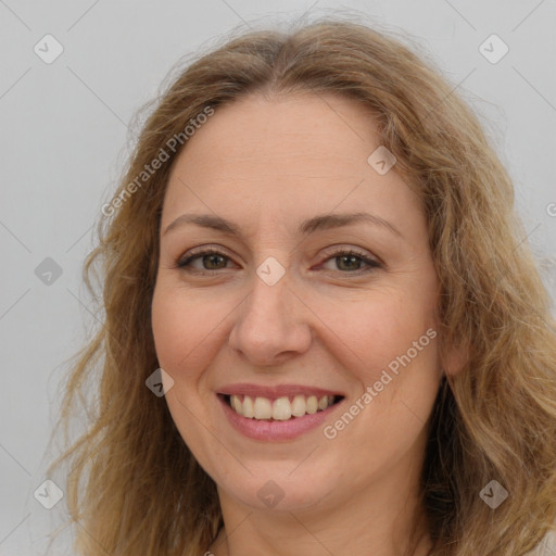 Joyful white adult female with long  brown hair and brown eyes