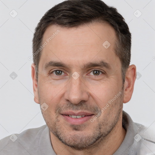 Joyful white adult male with short  brown hair and brown eyes