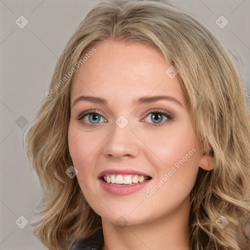 Joyful white young-adult female with long  brown hair and blue eyes