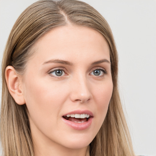 Joyful white young-adult female with long  brown hair and blue eyes