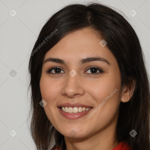 Joyful white young-adult female with long  brown hair and brown eyes