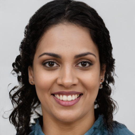 Joyful latino young-adult female with long  brown hair and brown eyes