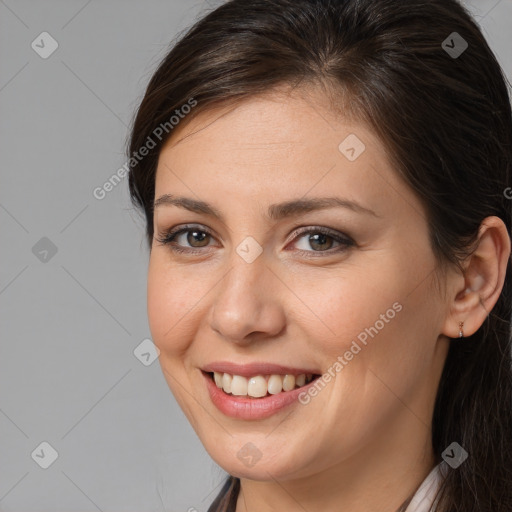 Joyful white young-adult female with long  brown hair and brown eyes