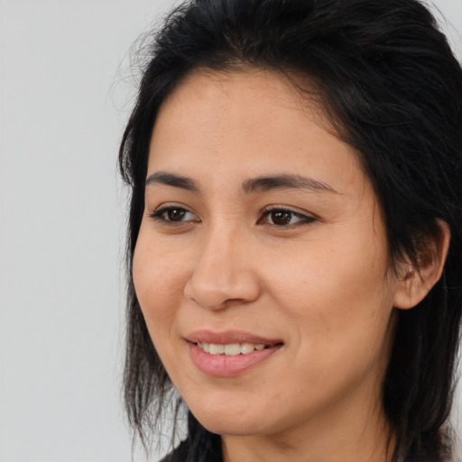 Joyful asian young-adult female with long  brown hair and brown eyes