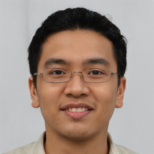 Joyful asian young-adult male with short  brown hair and brown eyes
