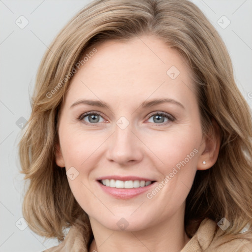 Joyful white young-adult female with long  brown hair and blue eyes