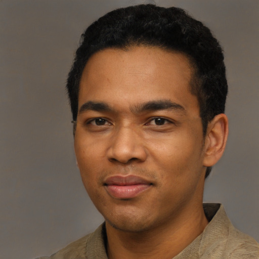 Joyful black young-adult male with short  black hair and brown eyes