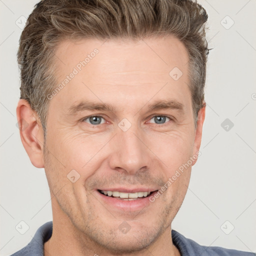 Joyful white adult male with short  brown hair and grey eyes