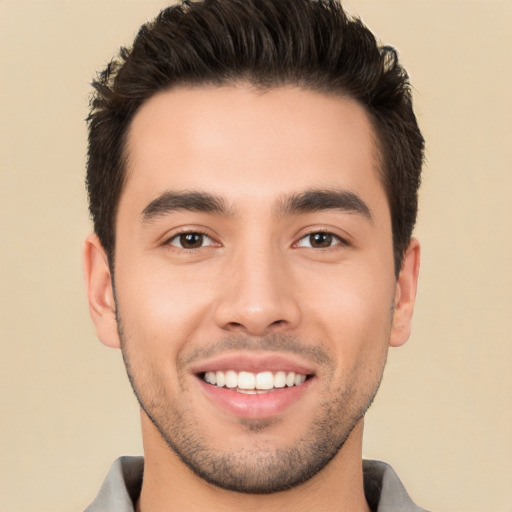 Joyful white young-adult male with short  black hair and brown eyes