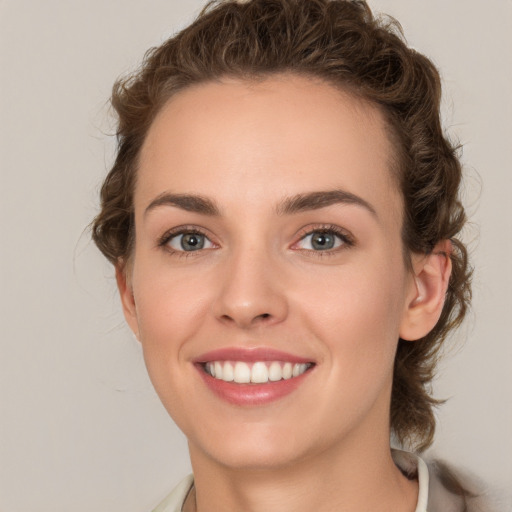 Joyful white young-adult female with medium  brown hair and green eyes