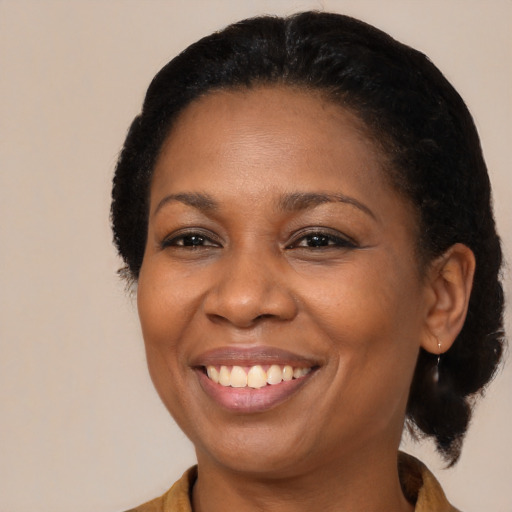 Joyful black adult female with medium  black hair and brown eyes
