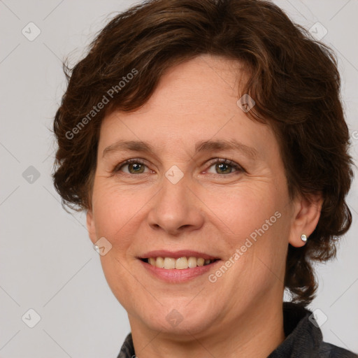 Joyful white adult female with medium  brown hair and green eyes