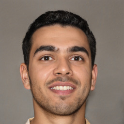 Joyful latino young-adult male with short  brown hair and brown eyes