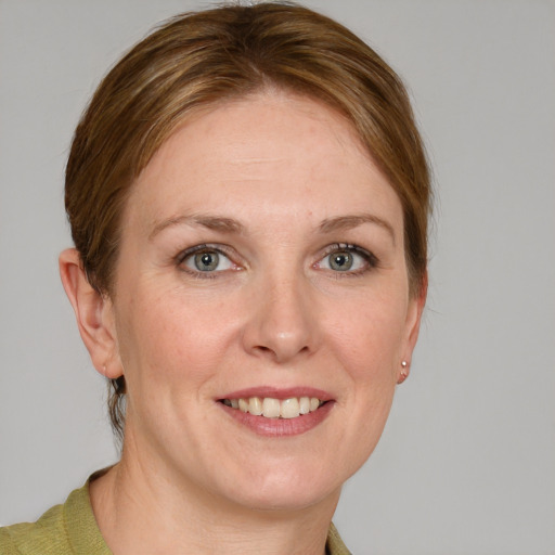 Joyful white young-adult female with medium  brown hair and blue eyes