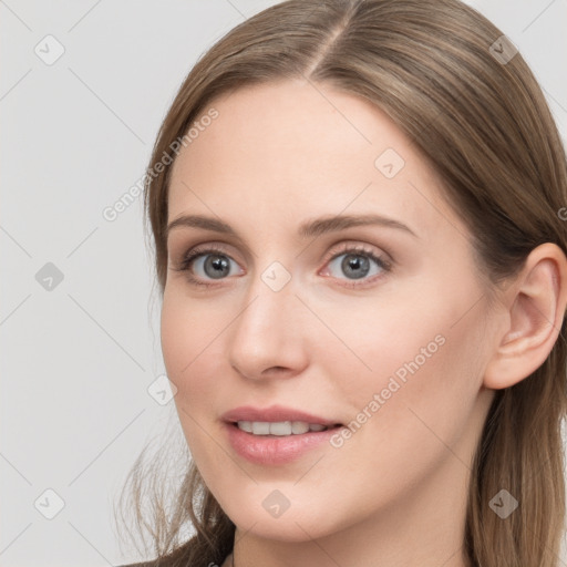 Joyful white young-adult female with long  brown hair and grey eyes