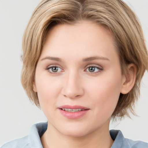 Joyful white young-adult female with medium  brown hair and blue eyes