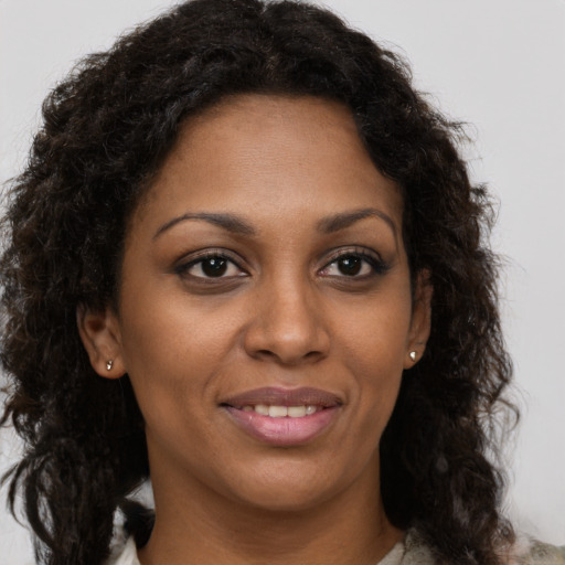 Joyful black young-adult female with medium  brown hair and brown eyes