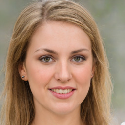 Joyful white young-adult female with long  brown hair and green eyes