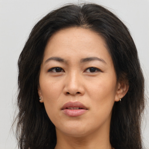 Joyful asian young-adult female with long  brown hair and brown eyes