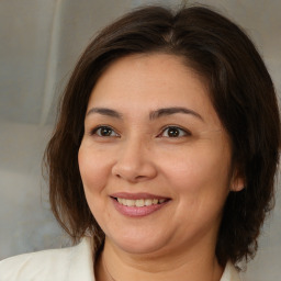 Joyful white adult female with medium  brown hair and brown eyes