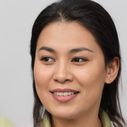 Joyful latino young-adult female with long  brown hair and brown eyes