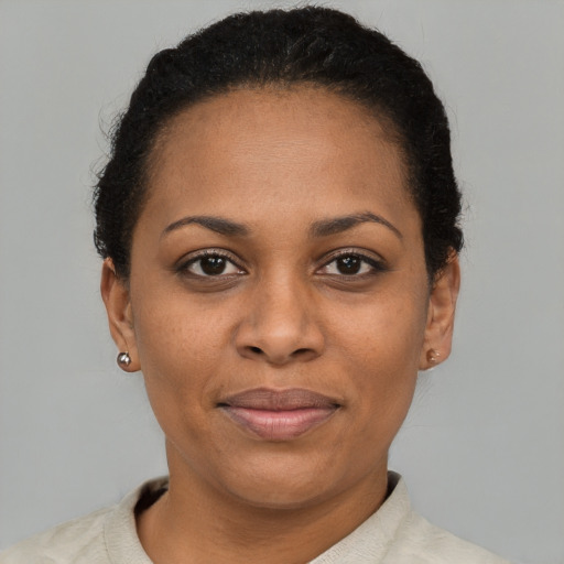 Joyful latino adult female with short  brown hair and brown eyes