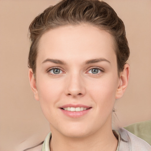 Joyful white young-adult female with short  brown hair and grey eyes