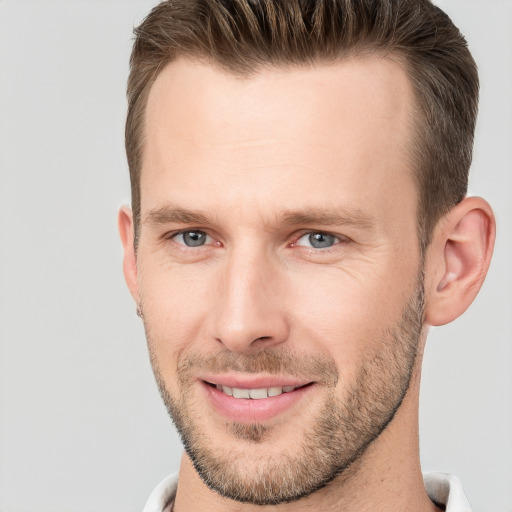 Joyful white adult male with short  brown hair and grey eyes