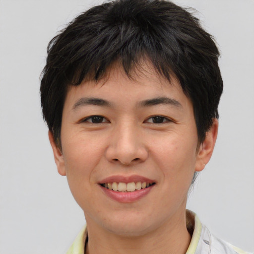 Joyful asian young-adult female with short  brown hair and brown eyes