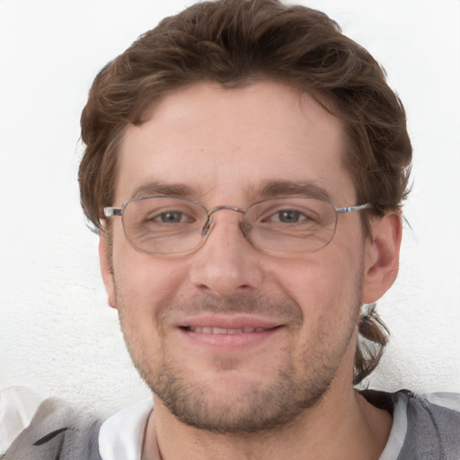 Joyful white adult male with short  brown hair and blue eyes