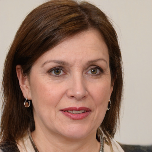 Joyful white adult female with medium  brown hair and grey eyes