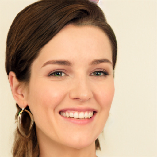 Joyful white young-adult female with long  brown hair and green eyes