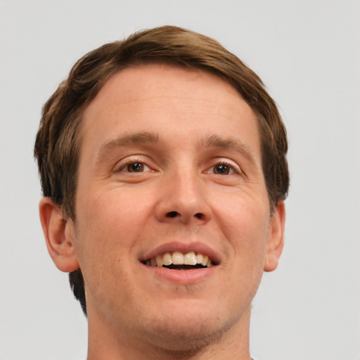 Joyful white adult male with short  brown hair and grey eyes