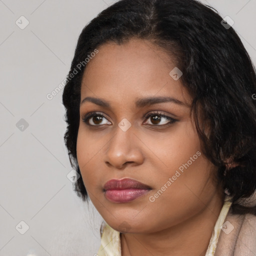 Joyful black young-adult female with medium  black hair and brown eyes