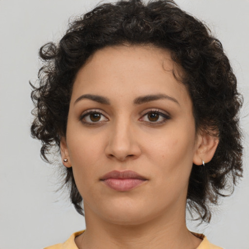 Neutral latino young-adult female with medium  brown hair and brown eyes