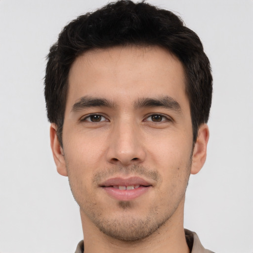 Joyful white young-adult male with short  black hair and brown eyes