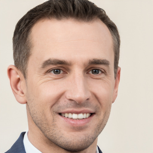 Joyful white adult male with short  brown hair and brown eyes