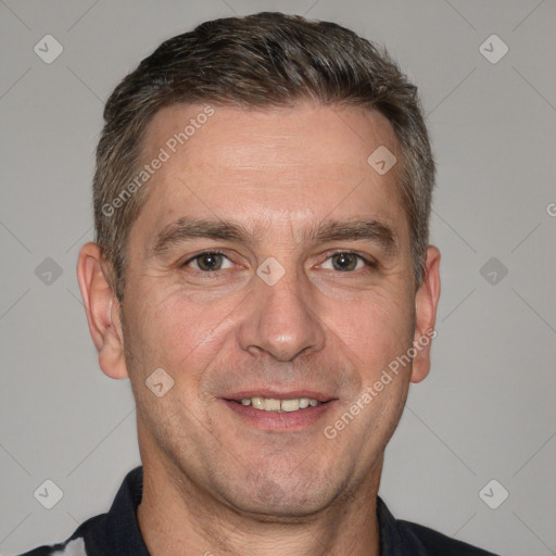 Joyful white adult male with short  brown hair and brown eyes