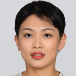 Joyful asian young-adult female with short  brown hair and brown eyes