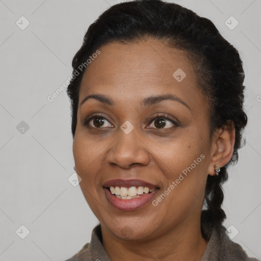 Joyful black adult female with short  brown hair and brown eyes