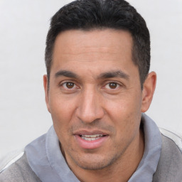 Joyful white adult male with short  black hair and brown eyes