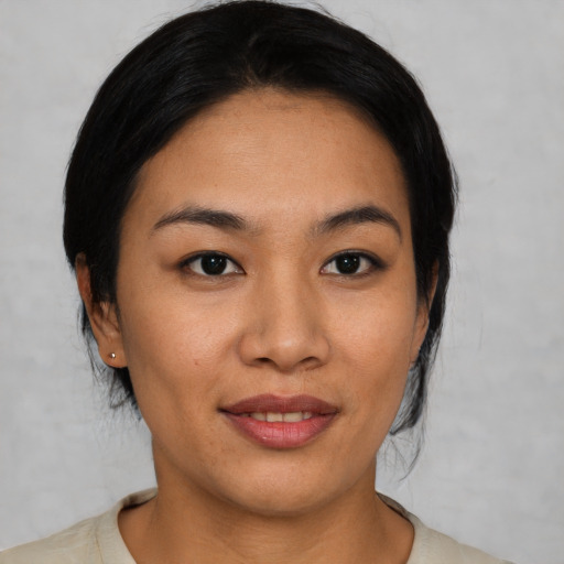 Joyful asian young-adult female with medium  black hair and brown eyes