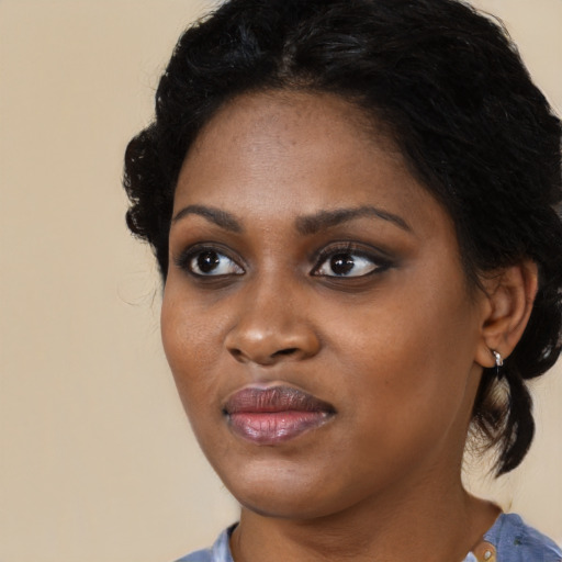 Joyful black young-adult female with medium  black hair and brown eyes