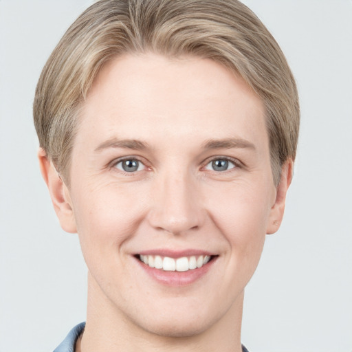 Joyful white young-adult female with short  brown hair and grey eyes