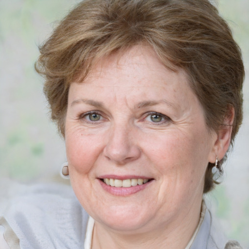 Joyful white middle-aged female with medium  brown hair and blue eyes