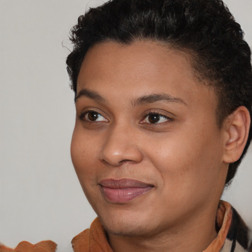 Joyful black young-adult female with short  brown hair and brown eyes