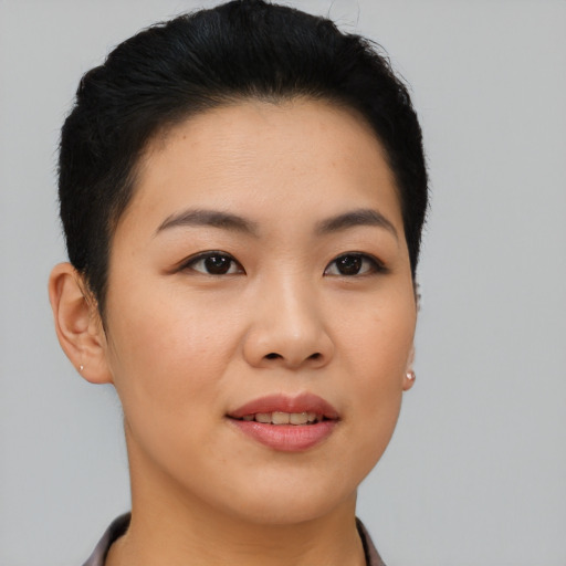 Joyful asian young-adult female with short  black hair and brown eyes