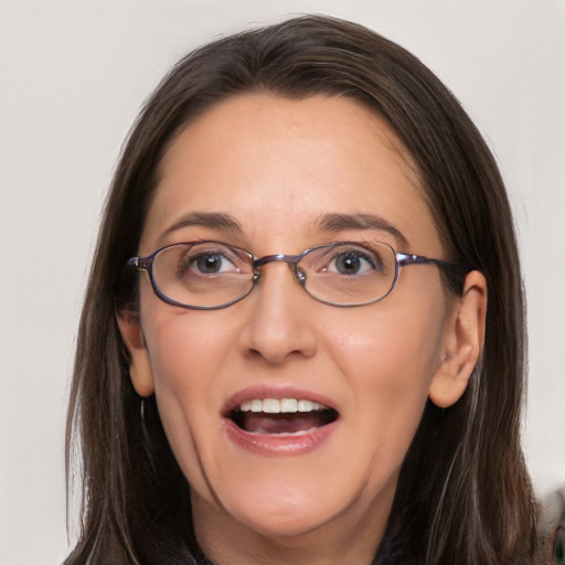 Joyful white adult female with long  brown hair and brown eyes