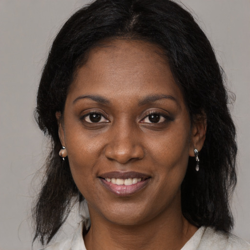 Joyful black young-adult female with medium  brown hair and brown eyes